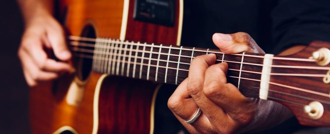 Photo of Person Playing Acoustic Guitar