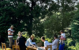 a group of people sitting around a wooden table